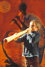 Young boy plays a Lur (wooden trumpet)