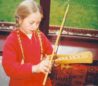 Child playing Pentatonic Psaltery (maker B.Weyeneth)