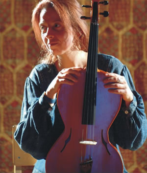 Student with new form of Viola, played like a viol resting on the lap (maker Choroi)